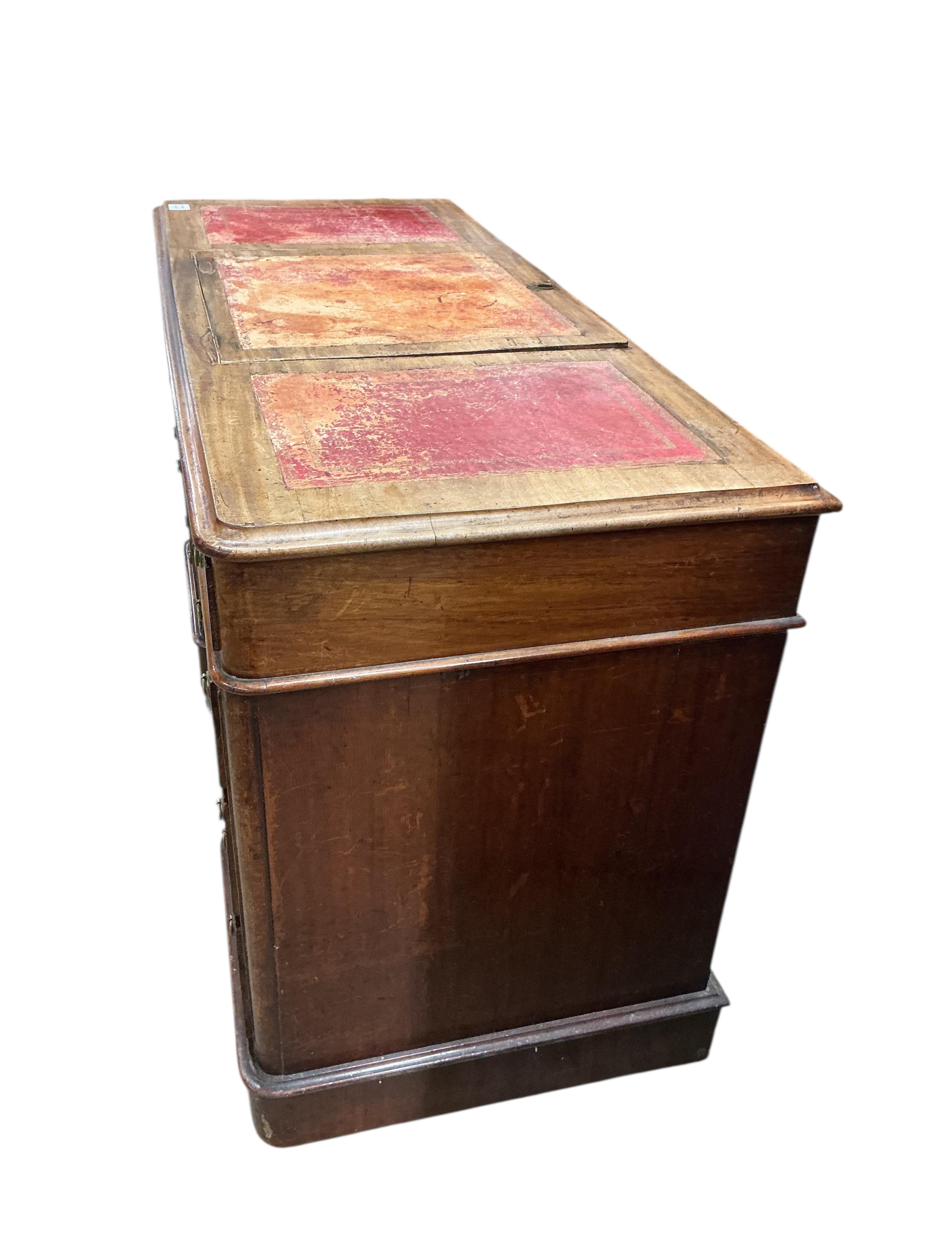 A Victorian mahogany pedestal desk, the top with hinged central section, width 122cm, depth 53cm, height 78cm